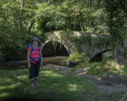 Aa old bridge. Linda in front f an old bridge.